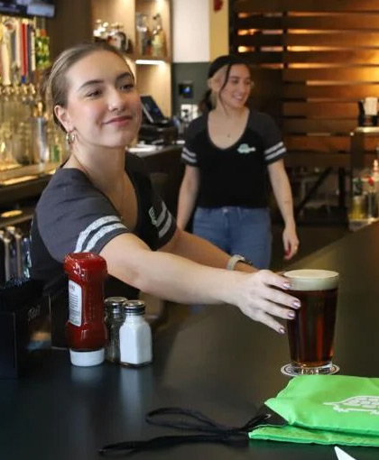 The Greene Turtle Bartender Serving Beverage