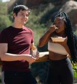 Young couple eating QDOBA on hike